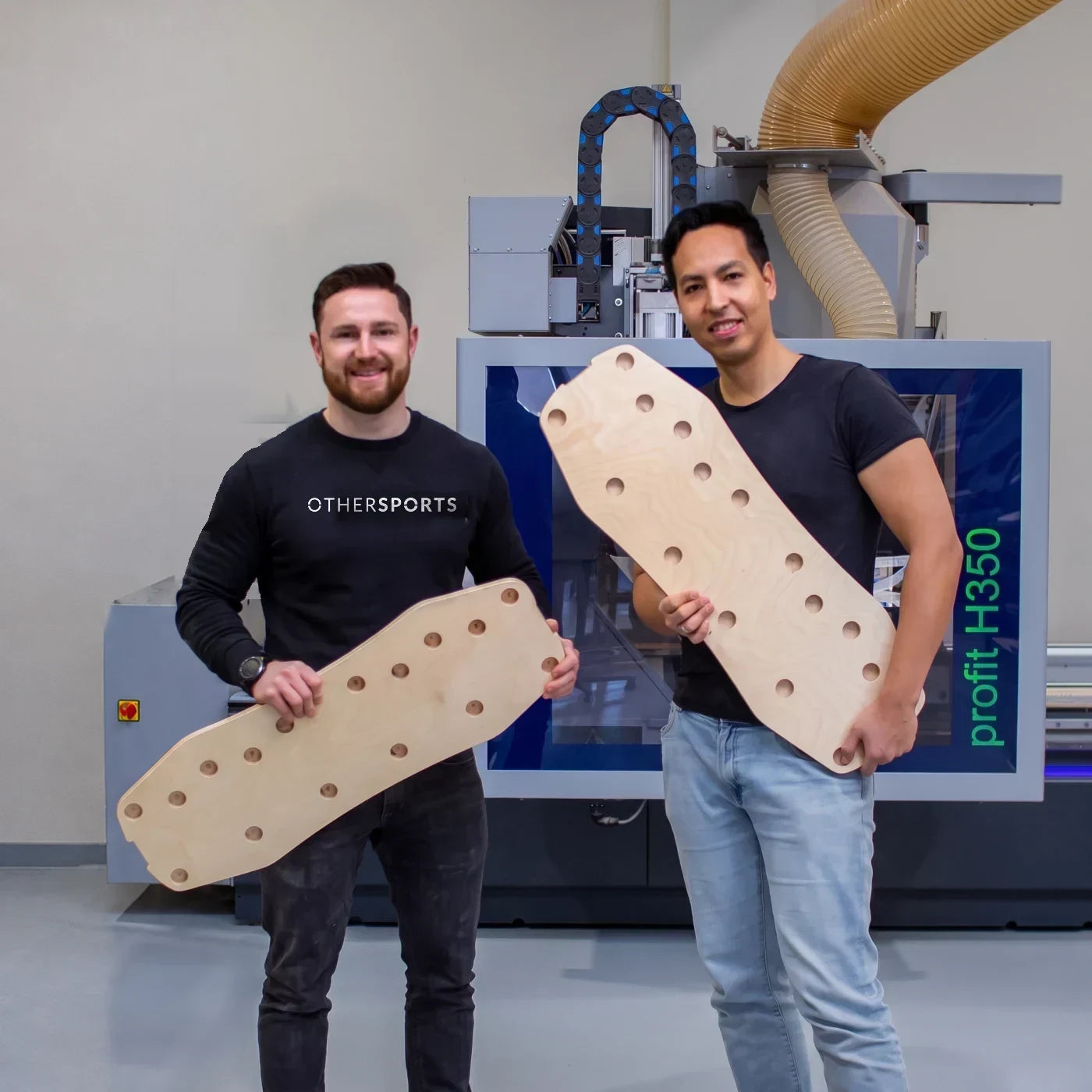 Christian Warth und Ronny Herrmann mit zwei Board-Rohlingen vor der CNC-Fräse in Baden-Württemberg